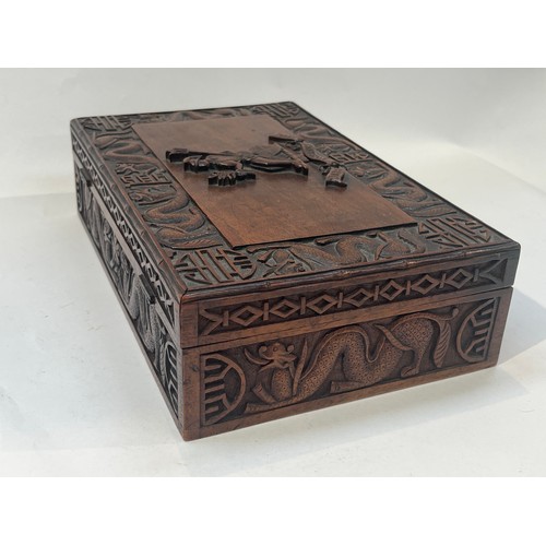 9386 - NORFOLK REGIMENT INTEREST: A Norfolk Regiment carved hardwood box, central crest with scroll, border... 