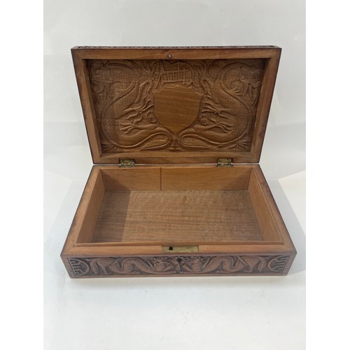 9386 - NORFOLK REGIMENT INTEREST: A Norfolk Regiment carved hardwood box, central crest with scroll, border... 