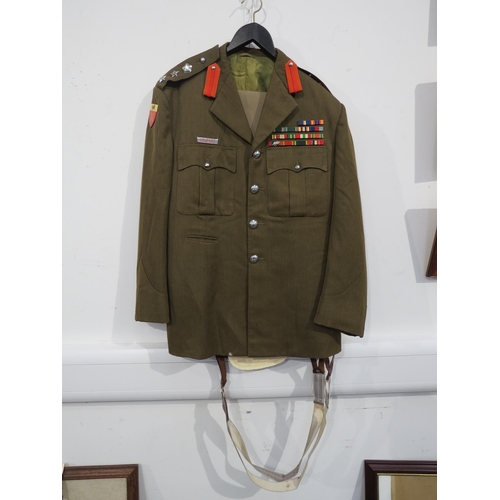 9094 - A South African colonel's uniform, the jacket with medal bar, together with two pairs of trousers an... 