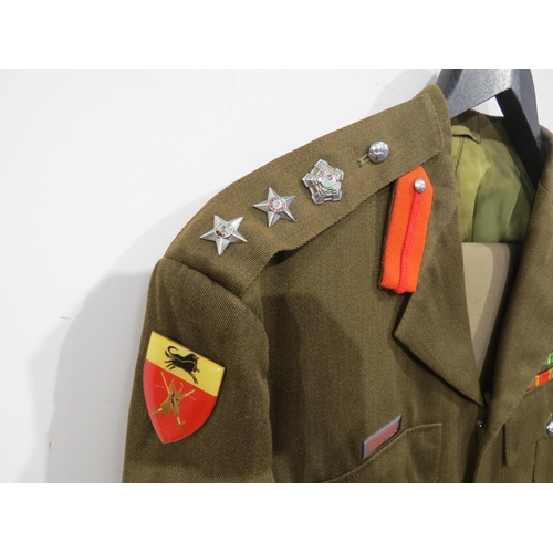 9094 - A South African colonel's uniform, the jacket with medal bar, together with two pairs of trousers an... 