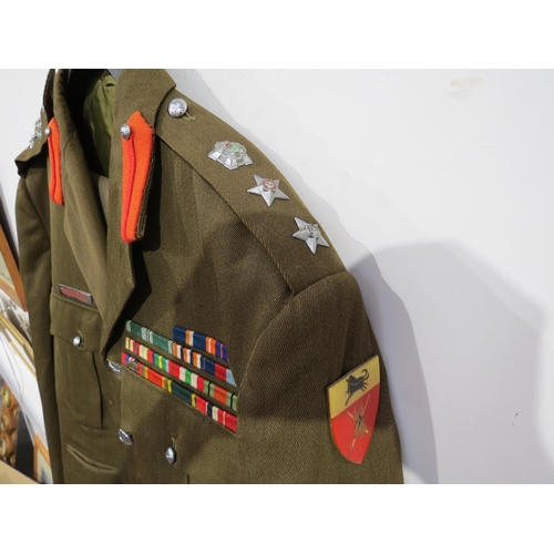 9094 - A South African colonel's uniform, the jacket with medal bar, together with two pairs of trousers an... 