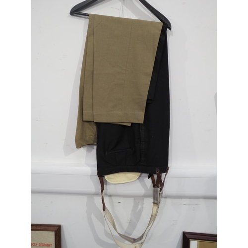 9094 - A South African colonel's uniform, the jacket with medal bar, together with two pairs of trousers an... 