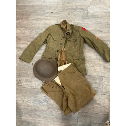 9127 - A WWI Brodie helmet with soldier's service jacket and breeches