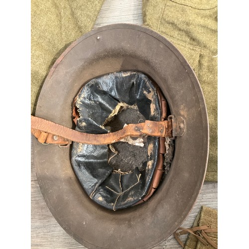 9127 - A WWI Brodie helmet with soldier's service jacket and breeches