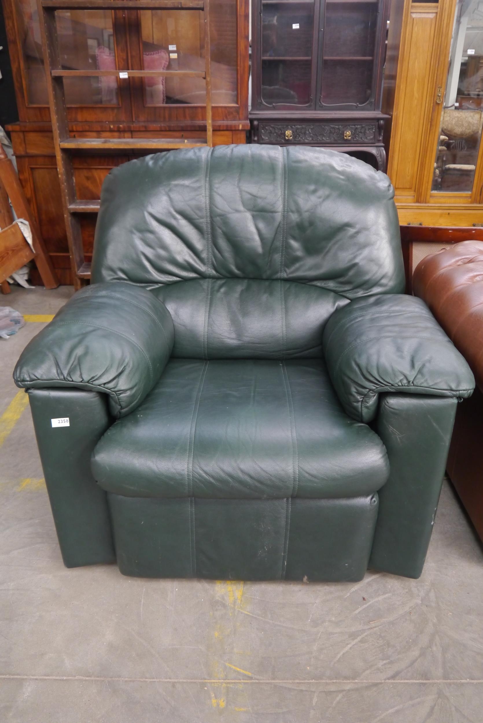 A green leather GPlan arm chair