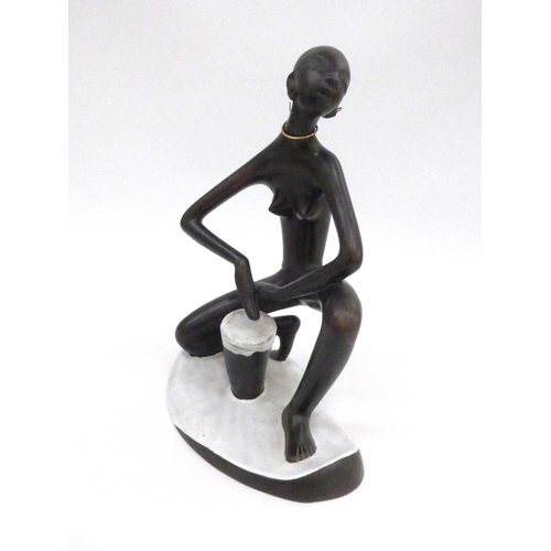 7008 - An Austrian Anzengruber Keramik African figure with drum. 27cm high