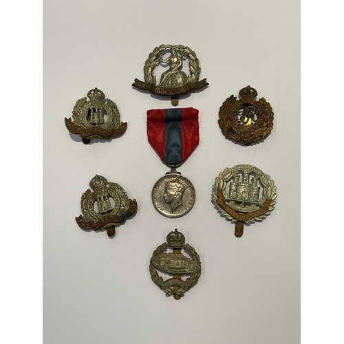 9516 - A George VI Imperial Service Medal named to HILDA LAURA MANN together with a quantity of cap badges