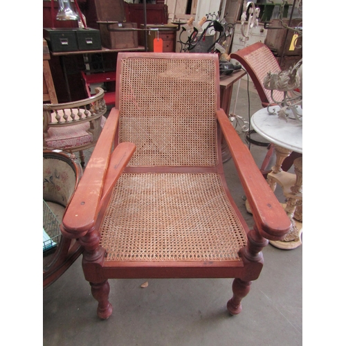 2003 - A pair of hardwood and cane plantation chairs