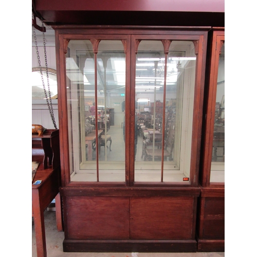 2108 - A mahogany glazed mirror back display cabinet with cupboard base