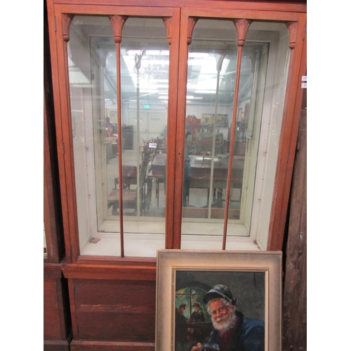 2109 - A mahogany glazed mirror back display cabinet with cupboard base