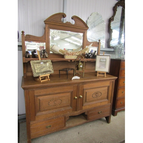 2121 - A 'Trevor Page & Co' oak dresser with mirrored back, two door, two drawers