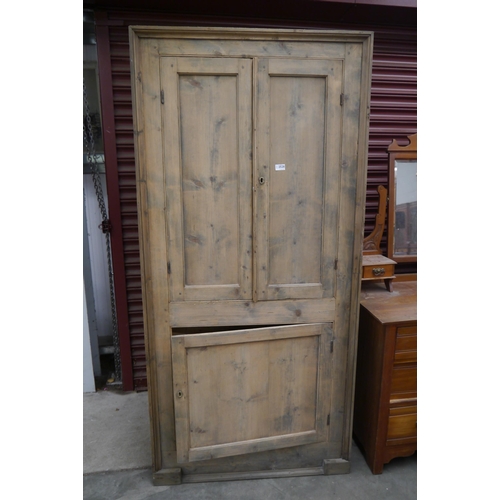 2528 - A Georgian stripped pine corner cupboard