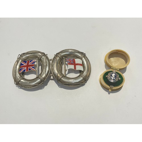 9530 - A silver belt buckle as two joining lifebelts, one with Union Flag, the other with White Ensign flag... 