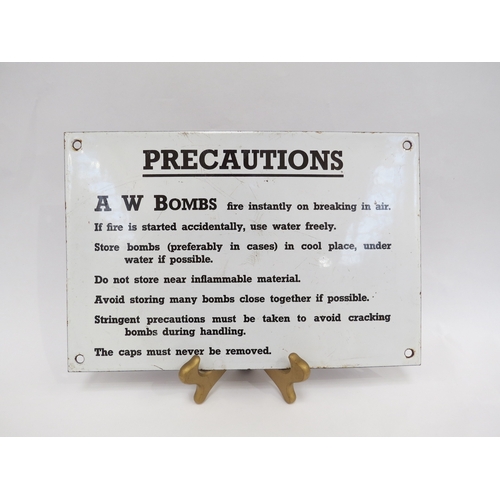 9243 - A WWII era enamel warning sign “PRECAUTIONS” with instructions on the storage of A W Bombs, white gr... 