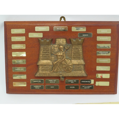 9257 - A Royal Anglian Regiment brass/bronze plaque on board with campaigns, together with a poster, badges... 