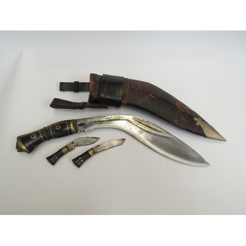 9331 - An early to mid 20th Century Kukri knife with horn grip and lion mask pommel, stamps to blade indist... 