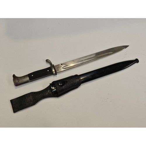 9340 - A WWII German K98 Police bayonet, the blade by Carl Eickhorn, Solingen, black grips, leather frog an... 