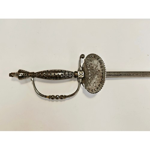 9357 - A cut steel court sword, the grip and guard with raised cut facets, rapier style blade inscribed San... 