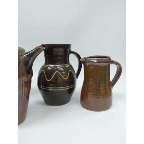 7127 - A collection of studio pottery jugs and a coffee pot from Winchcombe, Lowerdown etc, some a/f. Talle... 