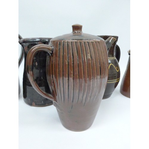 7127 - A collection of studio pottery jugs and a coffee pot from Winchcombe, Lowerdown etc, some a/f. Talle... 