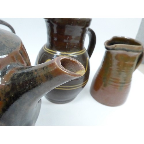 7127 - A collection of studio pottery jugs and a coffee pot from Winchcombe, Lowerdown etc, some a/f. Talle... 