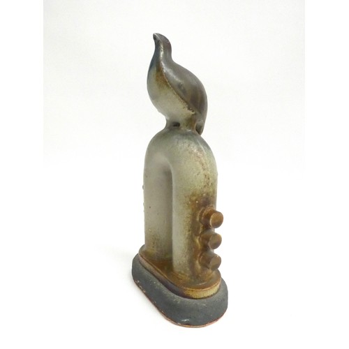 7046 - JORGE MEALHA (1934-2021) A studio ceramic figure of a bird on a pipe. Impressed seal. 31cm high