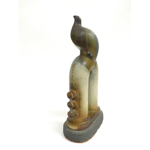 7046 - JORGE MEALHA (1934-2021) A studio ceramic figure of a bird on a pipe. Impressed seal. 31cm high