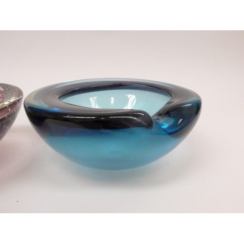 7258 - Two Art glass dishes in blue and in amethyst with controlled bubble, largest 16cm diameter