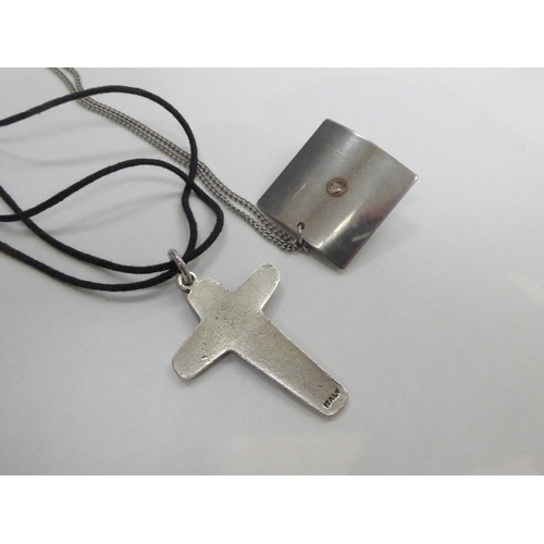 7344 - A 1960'a Italian crucifix on cord with silver fitting, plus a stainless steel 1960's pendant and cha... 