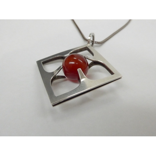 7338 - A Mid Century Finnish silver pendant and chain featuring a suspended carnelian orb centre stone, by ... 