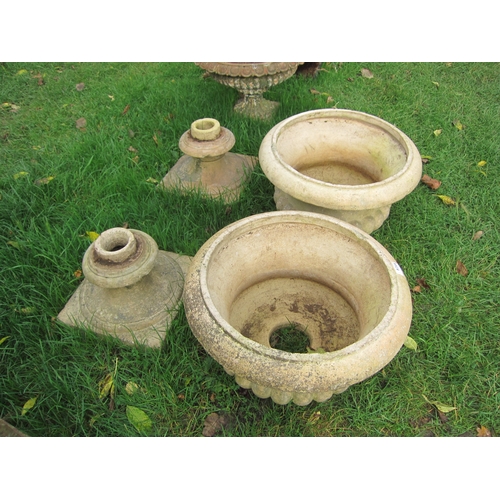 8259 - A pair of buff semi gadrooned urns on socle bases, 52cm tall