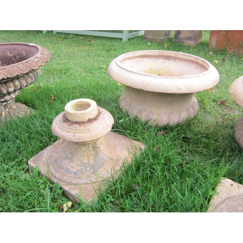 8259 - A pair of buff semi gadrooned urns on socle bases, 52cm tall