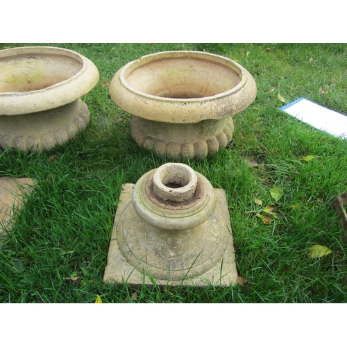 8259 - A pair of buff semi gadrooned urns on socle bases, 52cm tall