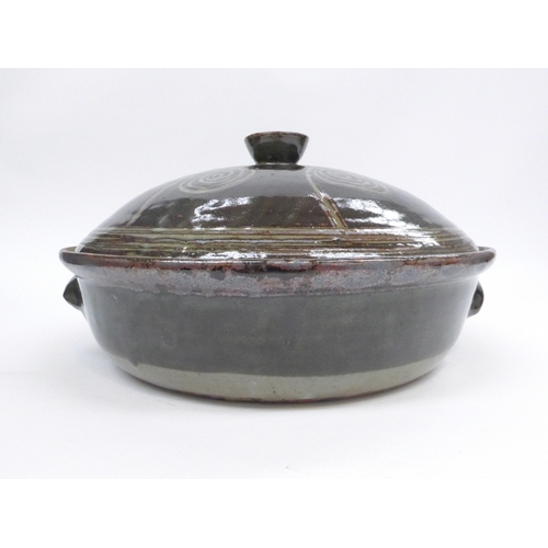 7154 - An Abuju Pottery large lidded casserole, tenmoku glaze with spiral detail.  Impressed seal for Kande... 