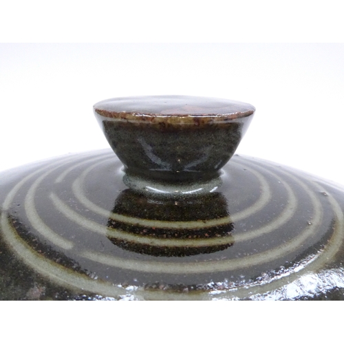 7154 - An Abuju Pottery large lidded casserole, tenmoku glaze with spiral detail.  Impressed seal for Kande... 