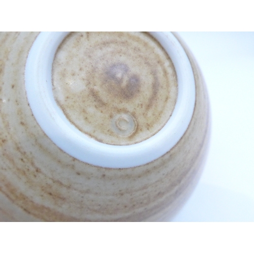 7159 - JOANNA CONSTANTINIDIS (1927-2000): A Studio porcelain bowl of flared form.  Banded oatmeal glaze. Im... 