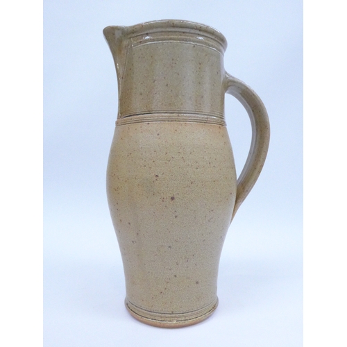 7082 - An A. & J. Young large stoneware jug with oatmeal glaze.  Impressed Gresham mark. 32cm high.