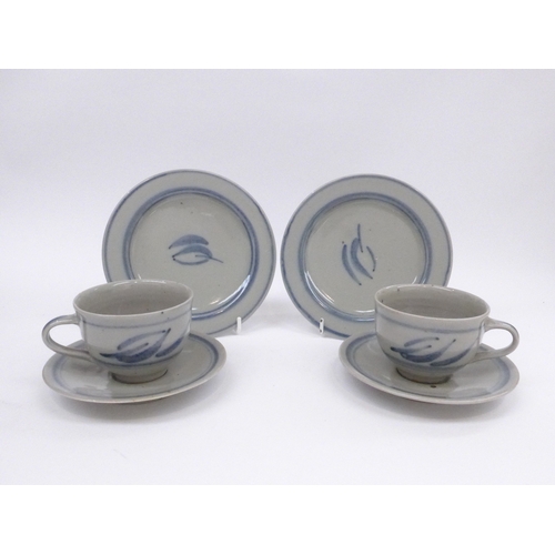 7065 - Two Crowan Pottery trios by Harry and May Davis with painted foliate detail in blue.  Impressed pott... 