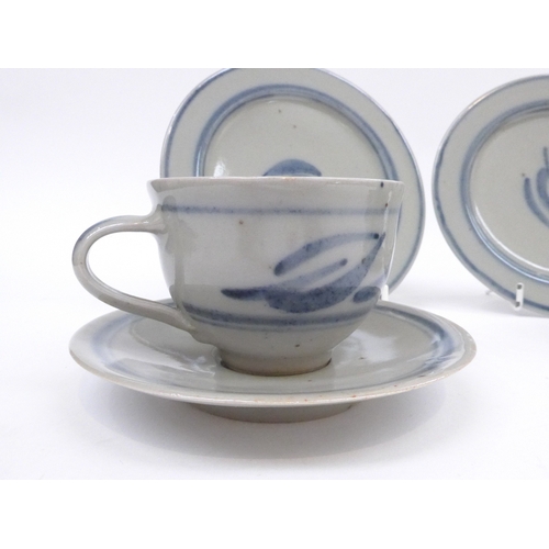 7065 - Two Crowan Pottery trios by Harry and May Davis with painted foliate detail in blue.  Impressed pott... 