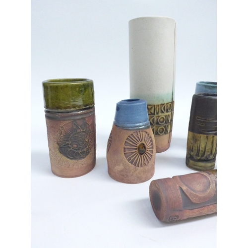 7092 - A collection of eight Bob Dawe Pottery cylindrical vases, various styles with relief moulded pattern... 