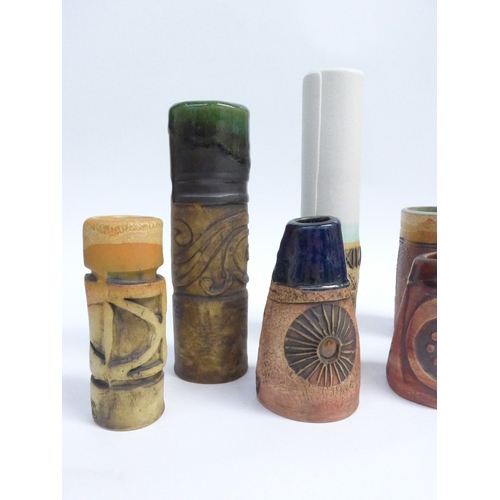 7090 - A collection of eight Bob Dawe Pottery cylindrical vases, various styles with relief moulded pattern... 