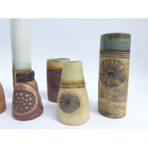 7090 - A collection of eight Bob Dawe Pottery cylindrical vases, various styles with relief moulded pattern... 