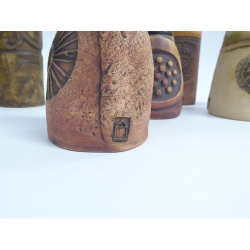 7090 - A collection of eight Bob Dawe Pottery cylindrical vases, various styles with relief moulded pattern... 