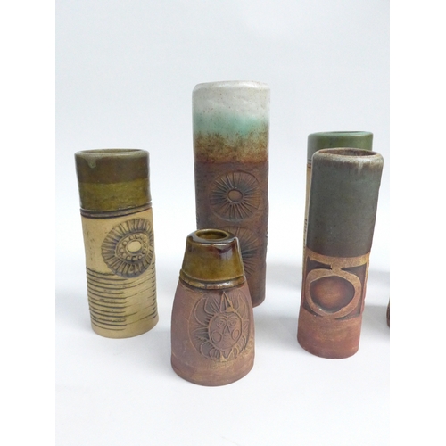 7094 - A collection of eight Bob Dawe Pottery cylindrical vases, various styles with relief moulded pattern... 