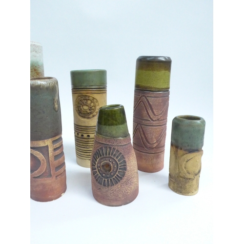 7094 - A collection of eight Bob Dawe Pottery cylindrical vases, various styles with relief moulded pattern... 