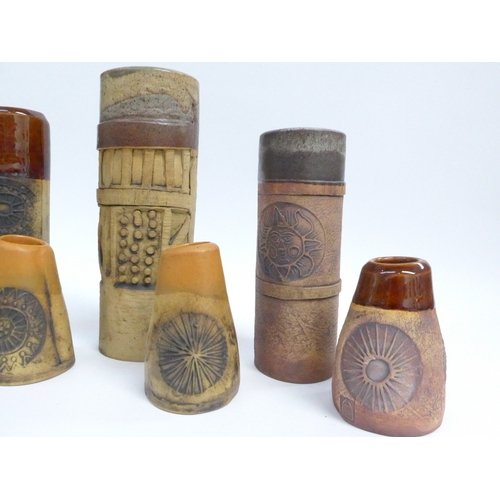 7096 - A collection of seven Bob Dawe Pottery cylindrical vases, various styles with relief moulded pattern... 