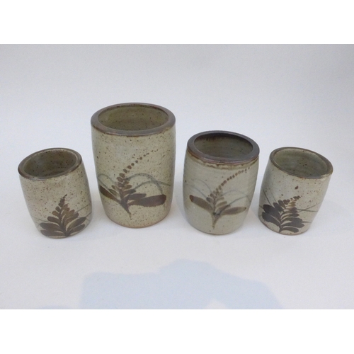 7114 - Four Lowerdown Pottery brush pots of various sizes, each painted with Foxglove pattern.  Pottery sea... 