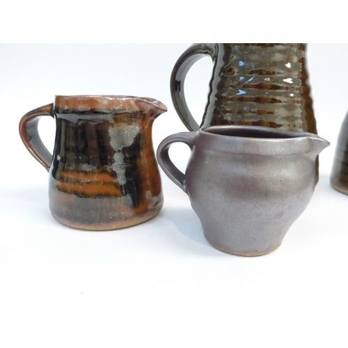 7051 - St Ives Leach Pottery - Four various jugs with tenmoku and similar glazes. Impressed Pottery seals o... 