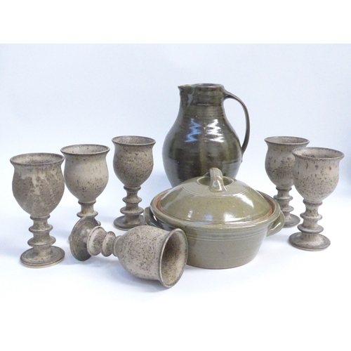 7073 - A collection of Studio pottery including green glazed jug, lidded casserole and a set of six goblets... 