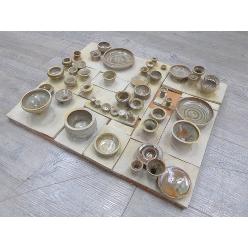 7042 - A mid 1970's ceramic wall art plaque with relief cup and saucer forms. Unmarked. 46.5cm x 39cm